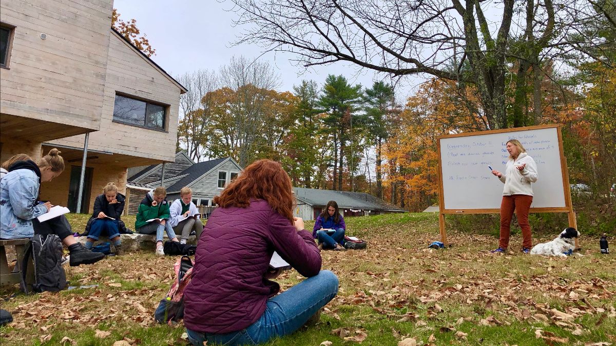 teacher and students outside with a whiteboard