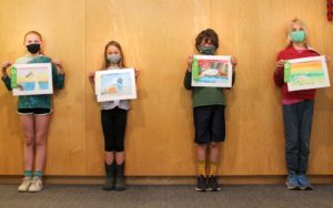 Students holding paintings of ducks