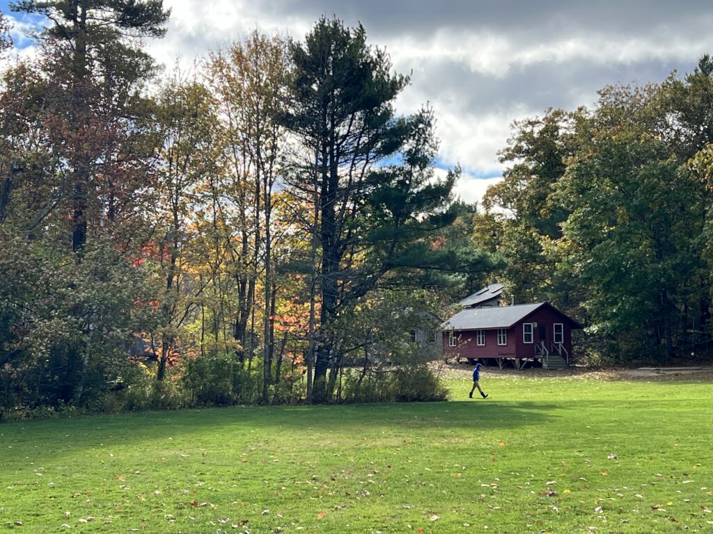 A student walks past beautiful fall foliage