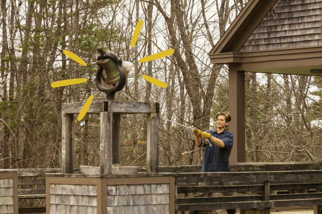 A staff member rings the Chewonki bell, signaling it's time for our community to gather.