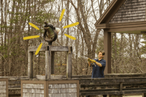 A staff member rings the Chewonki bell, signaling it's time for our community to gather.